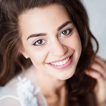 A beautiful woman smiling and showing a straight white smile