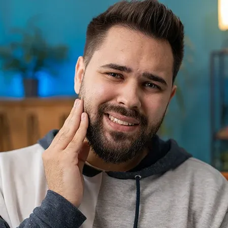 A man holding his jaw with pain